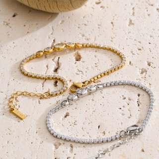 Juliette Bezel Tennis Bracelet in gold and silver finishes, each with clear stones and a graduated bezel-set center