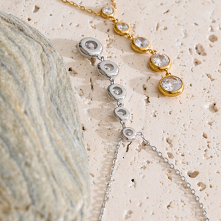 Juliette Drop Necklace in silver and gold-tone metal with graduated bezel-set clear stones and delicate lariat drops