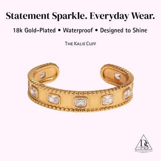 Kalie Cuff bracelet in gold with a wide band, beaded edges, and rectangular clear stones set across the front