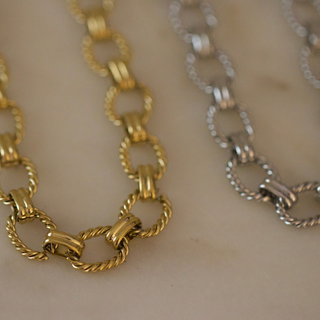 Laurel Link Necklace in gold and silver, featuring chunky oval links with twisted rope-textured edges and polished connectors