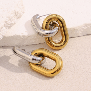 Linked Luxe Earrings in polished gold and silver-tone metal, featuring chunky interlocking chain links with a sculptural finish