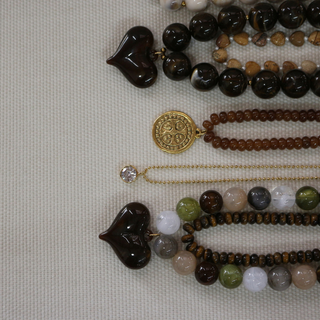 Millie Marbled Heart Necklace with glossy dark brown resin heart pendants and chunky round marbled beads in earthy tones