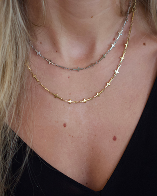 Mini Cross Necklace in gold and silver tones, featuring delicate stainless steel chains with small cross charms