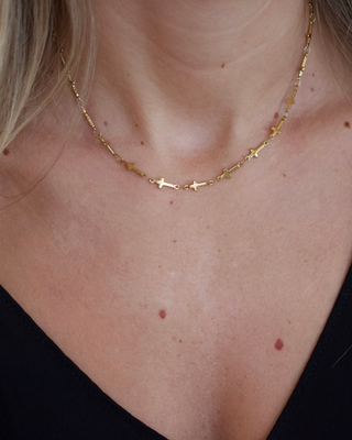 Mini Cross Necklace in gold-toned metal with a fine chain and tiny cross charms spaced along its length