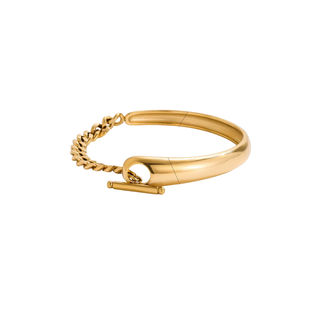 Monaco Curb Chain bangle bracelet in polished gold with a smooth sculptural band, curb-chain detail, and toggle closure