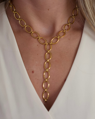 Oval Link Lariat Necklace in gold-tone metal with elongated oval links and a dangling chain drop design