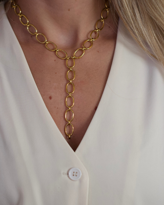 Oval Link Lariat Necklace in gold-tone metal, featuring elongated oval links and a long, vertical lariat drop
