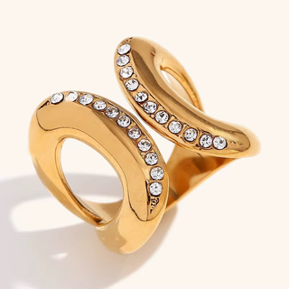 Parker sculptural CZ ring in glossy gold-tone metal with two looping curved bands lined with clear round stones