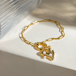 Pearl Heart Charm bracelet in gold-tone metal with a chunky paperclip chain and a polished heart pendant set with white pearls
