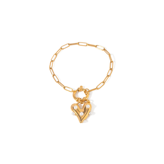 Pearl Heart Charm bracelet in gold-tone metal features a bold open heart pendant adorned with small white faux pearls