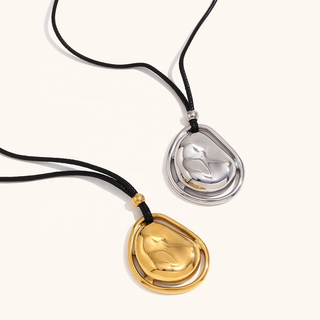 Pendant Cord Necklace with black cords and sculptural teardrop pendants in polished gold and silver finishes