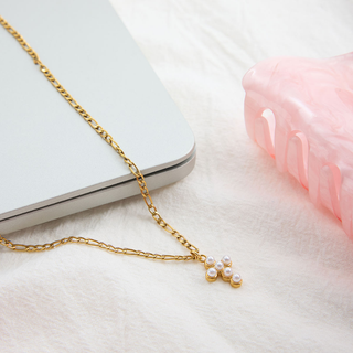 Petite Pearl Cross Necklace with a delicate gold chain and small cross pendant set with white faux pearls