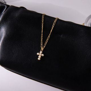 Petite Pearl Cross Necklace in gold-tone metal with a delicate chain and small cross pendant set with white pearl details