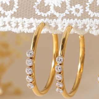 Portofino CZ hoop earrings in gold-tone metal with five clear round stones along each slim hoop.
