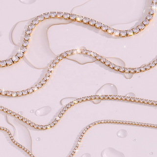 Rhinestone Tennis Necklace in gold-tone metal with continuous rows of clear square-cut stones in varying sizes