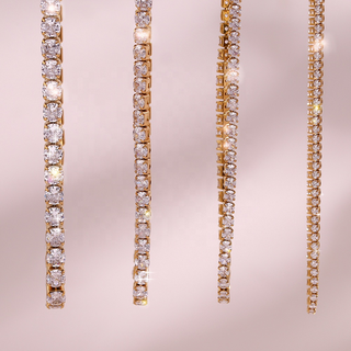 Rhinestone Tennis Necklace in gold-tone metal with clear sparkling stones, shown in four widths from bold to delicate