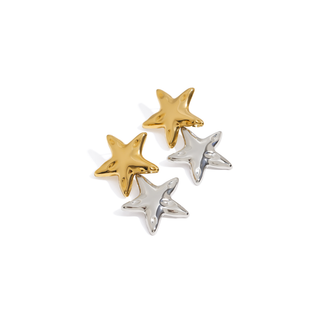 Riviera Star Earrings with polished gold and silver five-point star charms in a sculpted, dimensional design