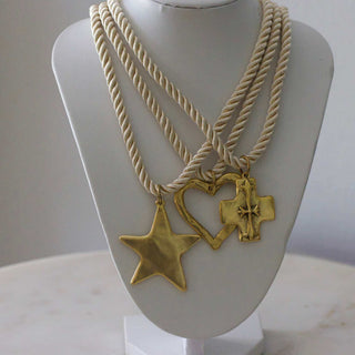 Silk Cord Pendant Necklace with cream twisted cords and three gold-tone star, heart, and cross charms