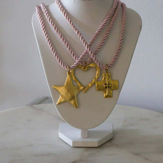Silk Cord Pendant Necklace with pink twisted silk cords and gold-tone star, heart, and cross pendants