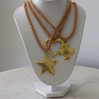 Silk Cord Pendant Necklace with tan twisted cords and three gold-tone star, heart and cross pendants