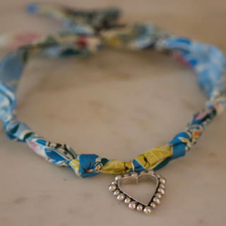 Silver Heart Scarf Necklace with a blue multicolour floral fabric band and an open heart pendant edged with silver beads