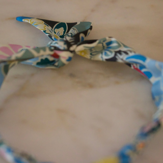 Silver Heart Scarf Necklace with a multicolour floral fabric tie in blue, teal, black, yellow and pink; pendant not visible