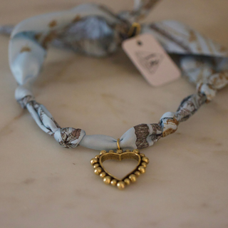 Skyline Heart Scarf Necklace with a pale blue and brown patterned fabric cord and a gold-tone beaded heart pendant