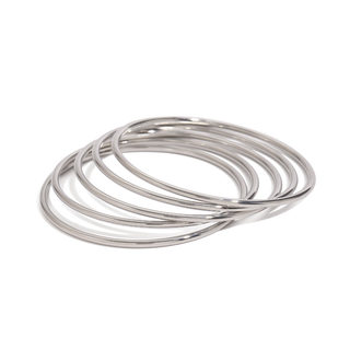 Stacking Bangles Set with five thin, polished silver-tone metal rings in a smooth, simple design