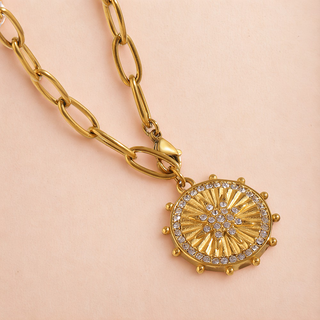 Sunburst Necklace with gold-tone oval-link chain and round radiating medallion, accented by clear sparkling stones