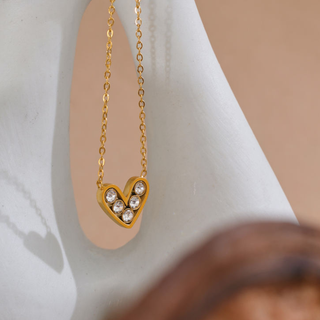 Sweetheart Heart Necklace in gold-tone metal with a heart-shaped pendant set with several sparkling clear stones