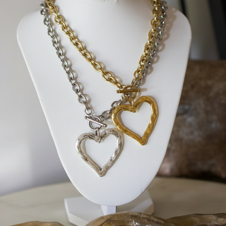Sweetheart Toggle Necklace with layered gold and silver chains, open heart pendants, and toggle closures