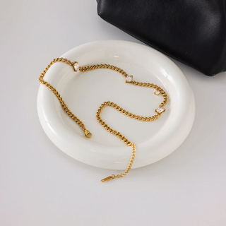 Torino star curb chain necklace in gold-tone metal with a fine curb chain and spaced clear star-shaped accents