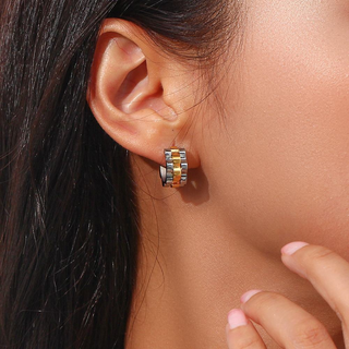 Two-Tone Braided Huggie Earrings in gold and silver with a chunky woven pattern and compact hoop shape