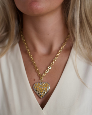 Wild Heart Necklace with a gold etched chain and heart pendant featuring a gold leopard pattern and silver-tone frame