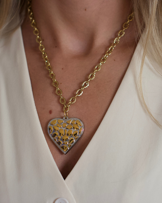 Wild Heart Necklace with a gold leopard-pattern heart pendant, silver-tone border, and chunky textured gold chain