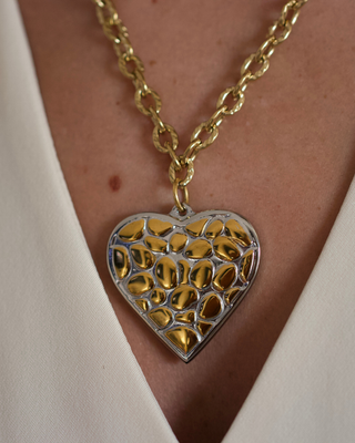 Wild Heart Necklace in gold and silver-tone metal, with a textured gold chain and heart pendant featuring a leopard pattern.