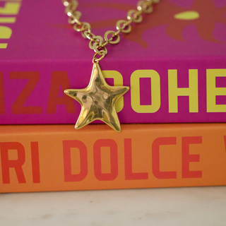 Wish Upon a Star Necklace with a polished gold-tone chain and puffy five-point star pendant with a reflective finish