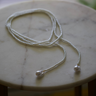 Wrap Pearl Lariat Necklace with a delicate silver-tone chain and two luminous white pearl accents at the ends
